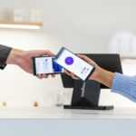 Customer paying with smartphone at point of sale terminal.