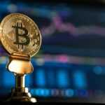 selective focus photo of Bitcoin near monitor